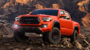 Front angle view of new orange 2023 Toyota Tacoma midsize pickup truck, highlighting how much a fully loaded one costs