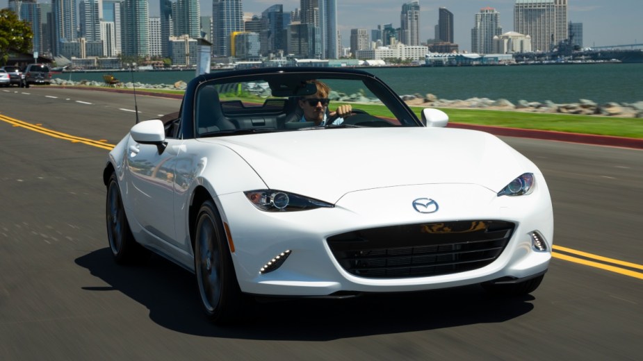 Front view of white 2022 Mazda MX-5 Miata, affordable sports car alternative to Ford Mustang costs less than $30,000