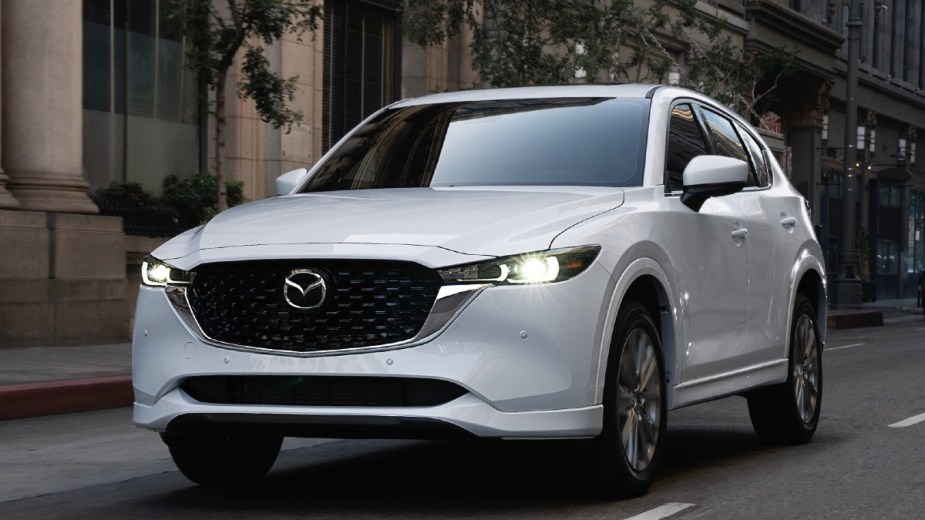Front angle view of white 2023 Mazda CX-5 crossover SUV, highlighting how much a fully loaded one costs