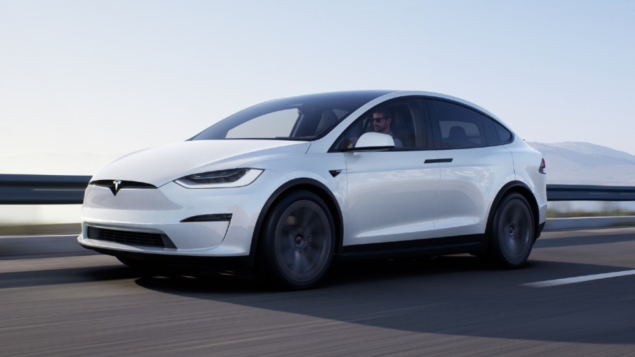 Front angle view of white Tesla Model X, highlighing cheaper electric luxury SUVs that are cheaper
