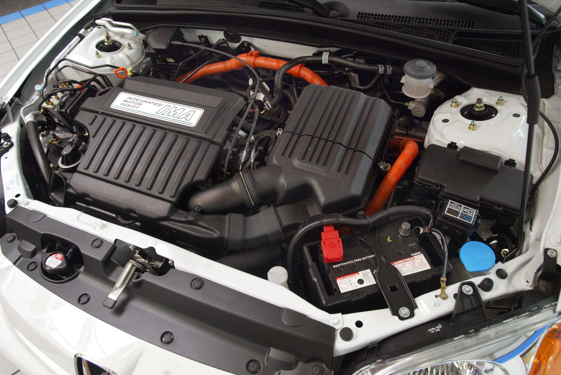 Looking at the engine and powertrain setup under the hood of a 2003 Honda Civic Hybrid