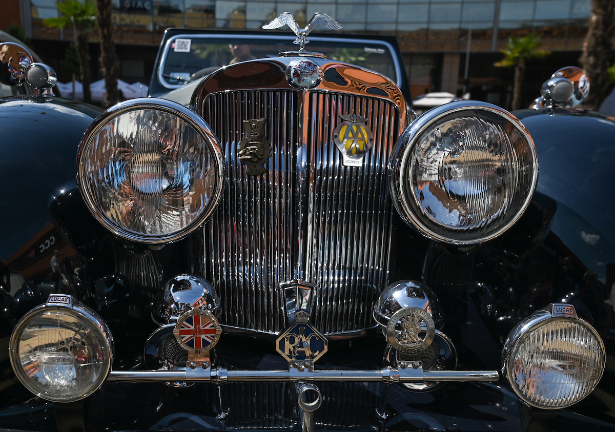 A car with a hood ornament, one of the car features from the past