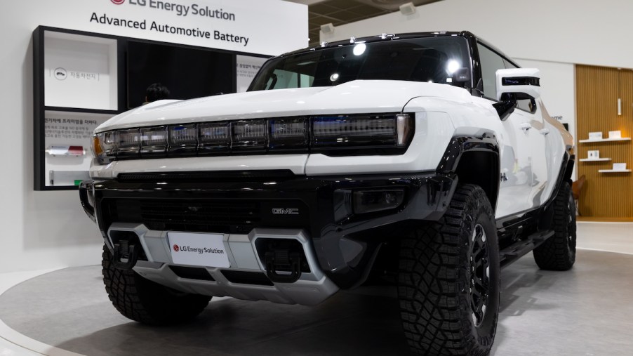 A white GMC Hummer parked indoors.