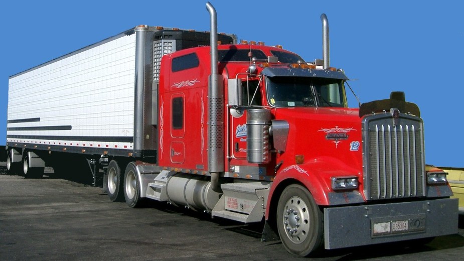 Red Kenworth Semi-Truck with trailer staged