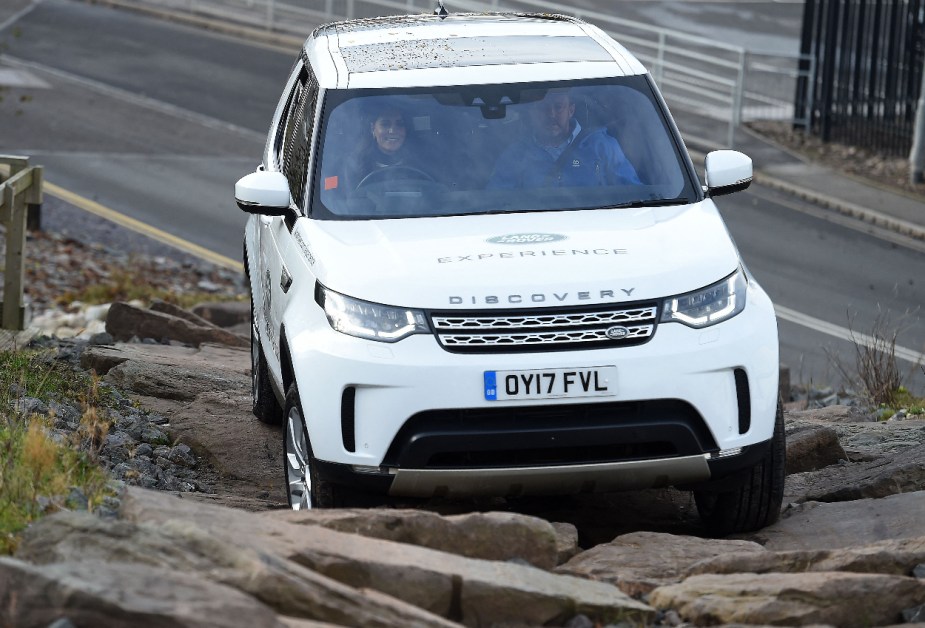 A white Land Rover Discovery shows off its off-road capability.