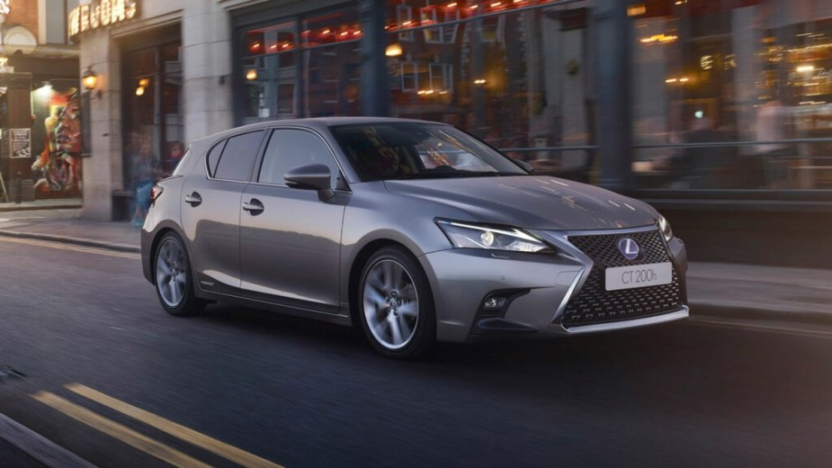 Gray Lexus CT 200H driving down a road