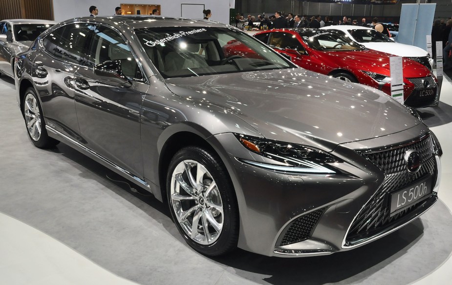 The Lexus LS 500 sits on a showroom floor at an auto show.