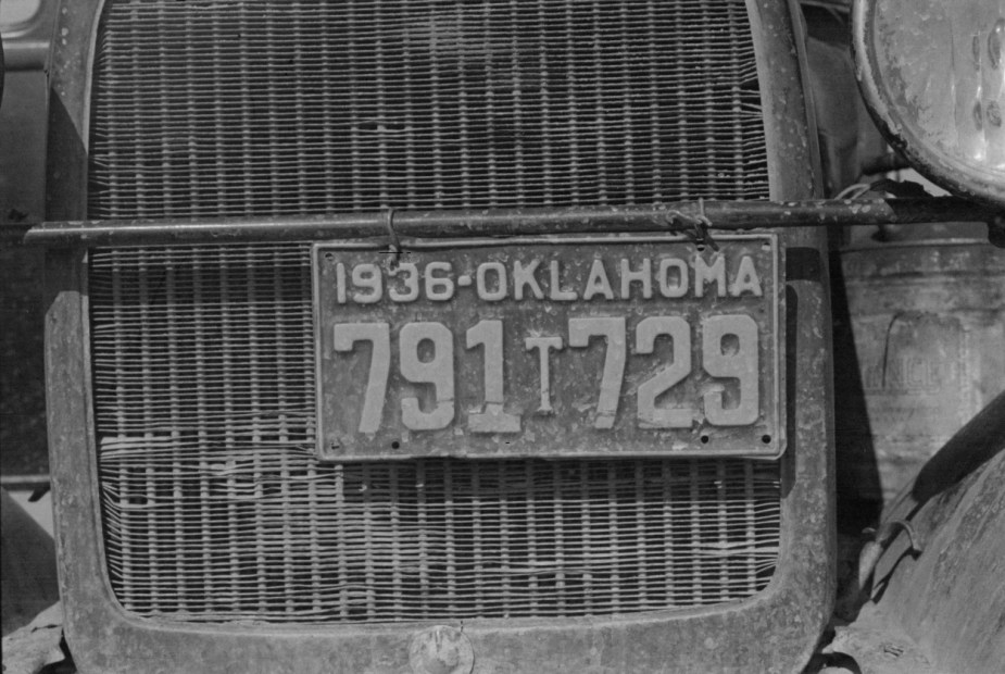An old license plate on a vintage car from Oklahoma.