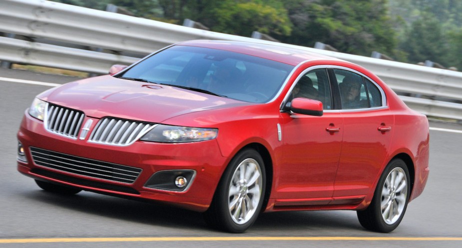A red 2010 Lincoln MKS drives on a test track.