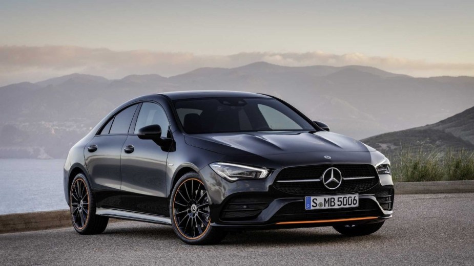 Black Mercedes-Benz CLA posed with a sunset