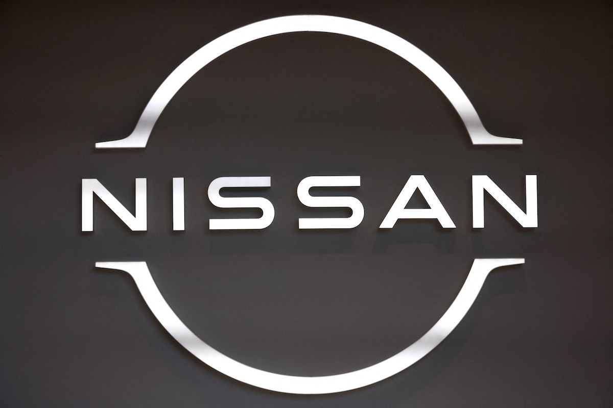 A black and white Nissan logo, maker of the 2023 Nissan Maxima.