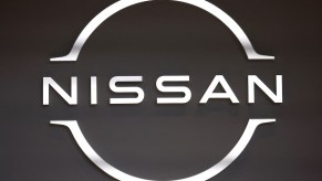 A black and white Nissan logo, maker of the 2023 Nissan Maxima.