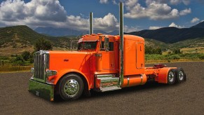 Bright Orange Peterbilt Semi-Truck with mountain background