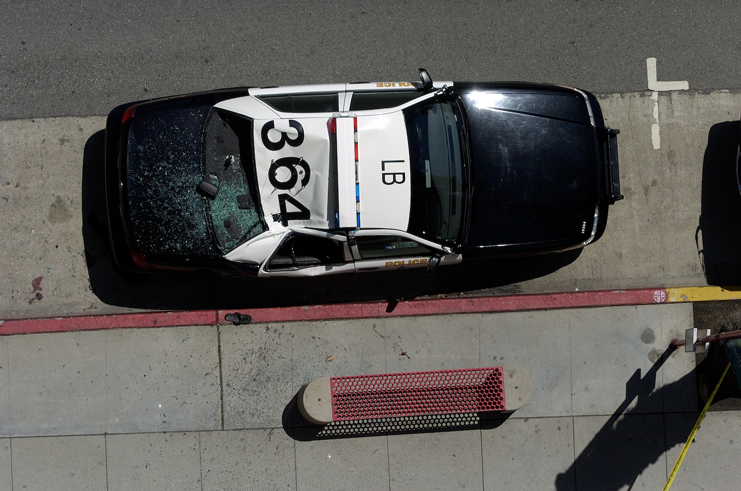 Bird's eye view of a black and white police car in Los Angeles, the numbers on its roof clearly visible.