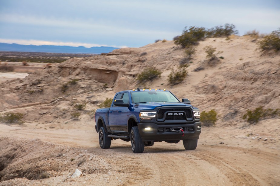Ram 2500 Power Wagon navigating a twisty dirt road, the desert visible in the background.