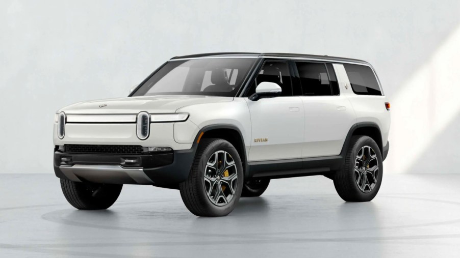 A white 2022 Rivian R1S electric SUV is parked.