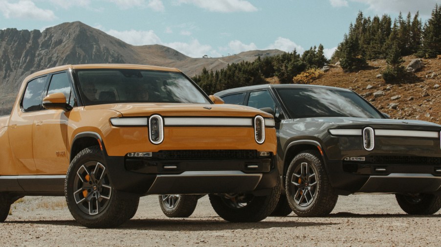 A yellow (L) and green (R) Rivian R1T electric pickup truck.