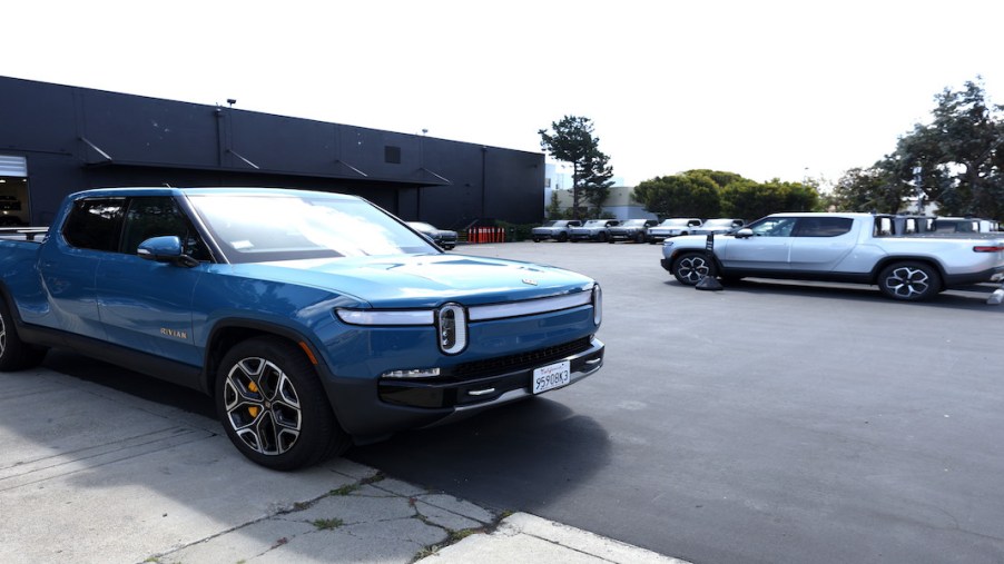 A Rivian R1T parked outside a building.