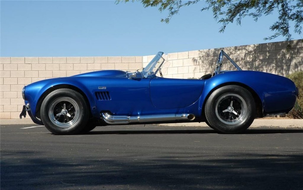 A blue Shelby Cobra, CSX3303, shows off its fat tires and roadster shape.  