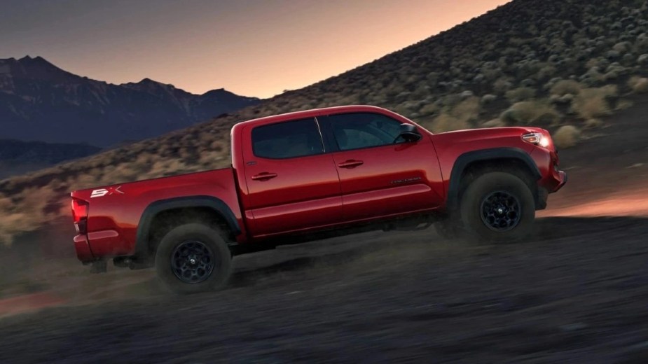 Side view of Barcelona Red Metallic 2023 Toyota Tacoma midsize pickup truck