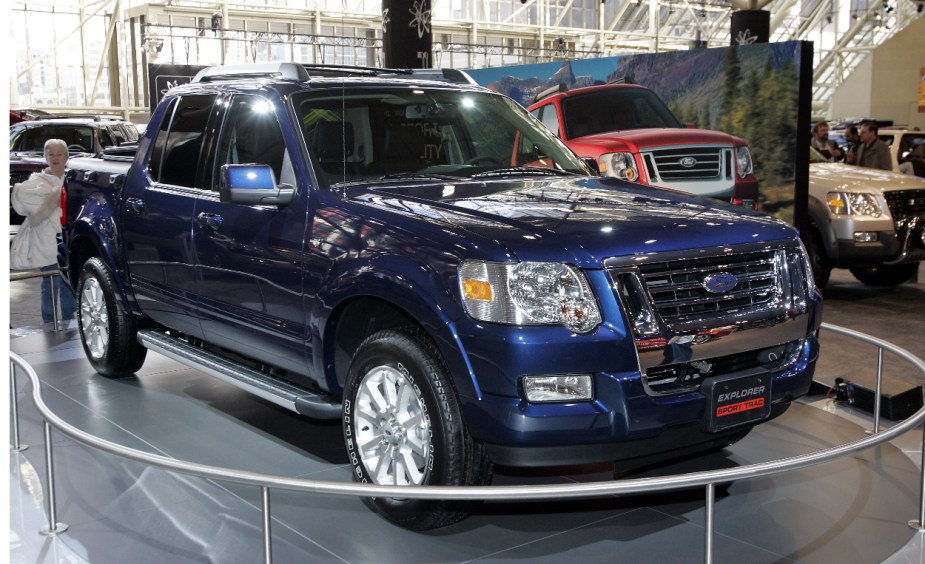 A blue Ford Explorer Sport Trac sits at an auto show.