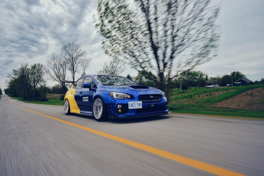 A blue Subaru preparing to street race