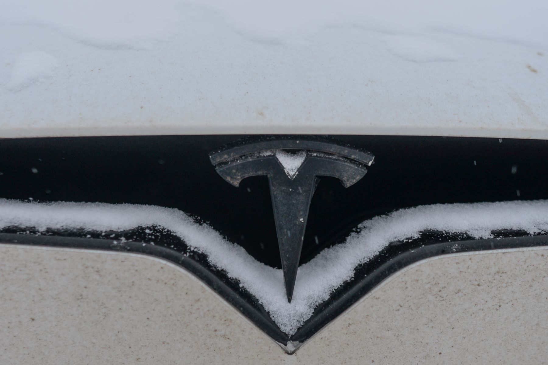 A Tesla EV parked in cold weather and covered in snow in Edmonton, Alberta, Canada