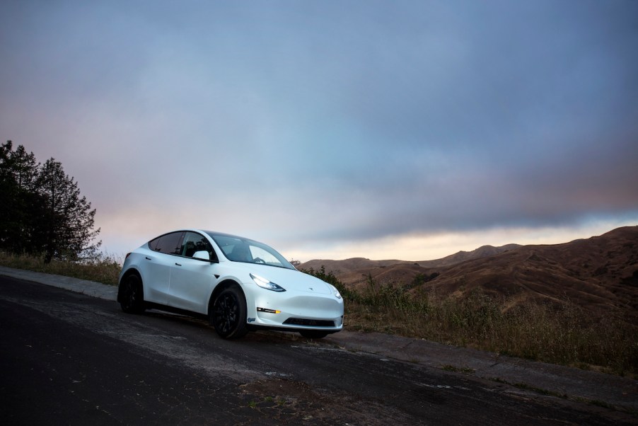 A white Tesla with full-self driving in a desert area.