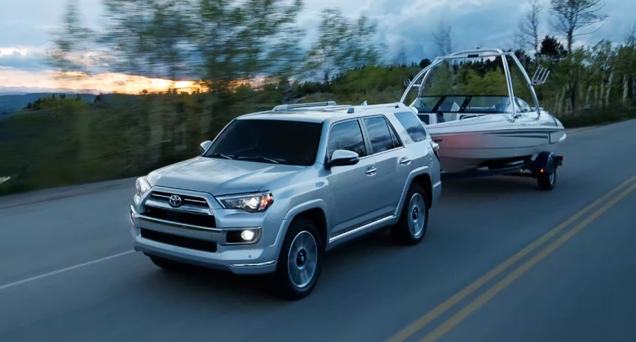A gray 2022 Toyota 4Runner full-size SUV is towing a boat. 
