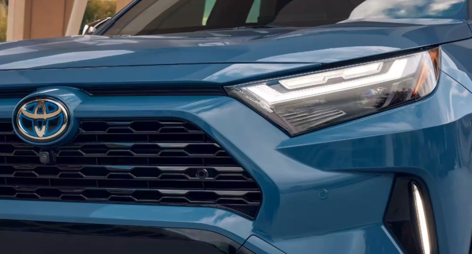 The front right of a blue Toyota RAV4 Hybrid small hybrid SUV.