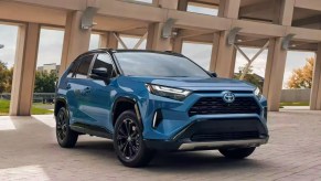 A blue 2022 Toyota RAV4 Hybrid small SUV is parked.