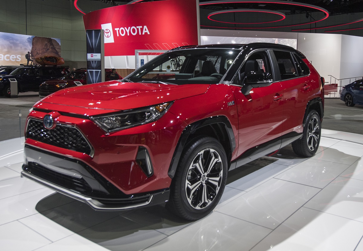 A red RAV4 Prime at an auto show. The RAV4  Prime has set a standard for PHEVs, but there a lot of great alternatives. 