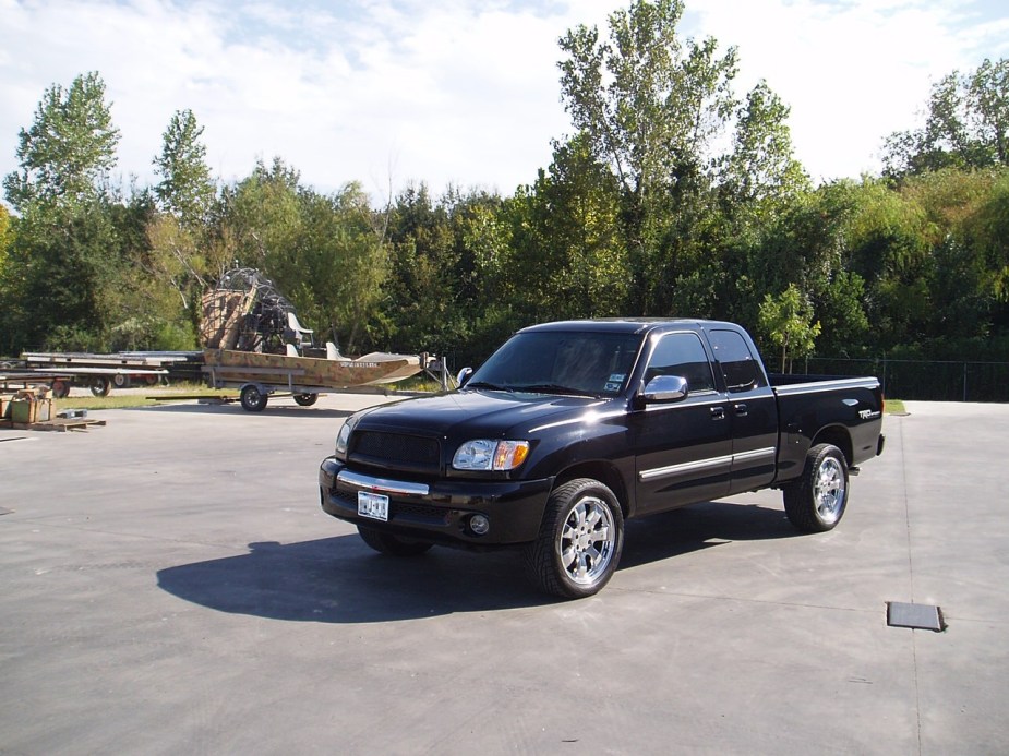 A black first-generation Toyota Tundra shows off its styling as a full-size truck.