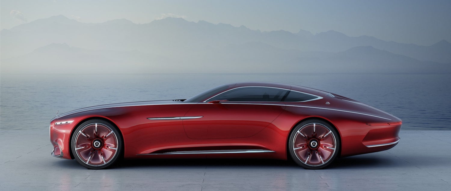 Futuristic Mercedes-Maybach concept coupe in red, a barely visible mountain range in the background.