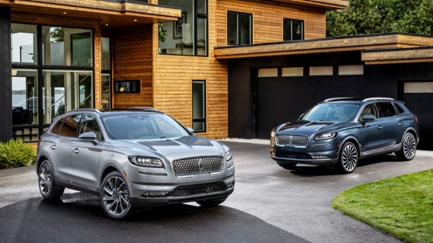 2 2022 Lincoln Nautilus SUVs parked at a modern home driveway 