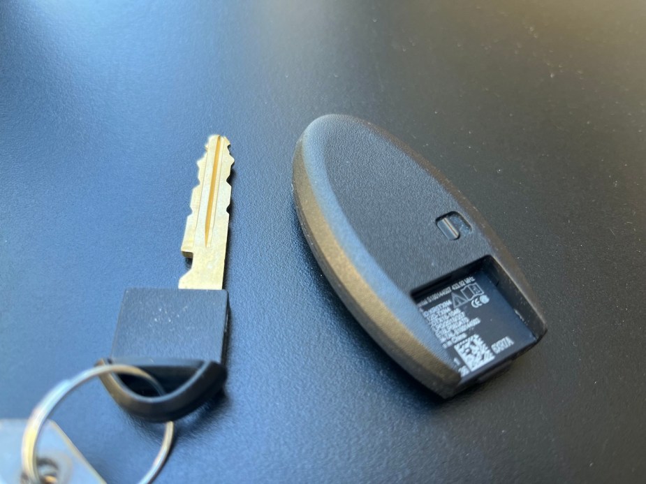 A Nissan key fob with the valet key next to it.