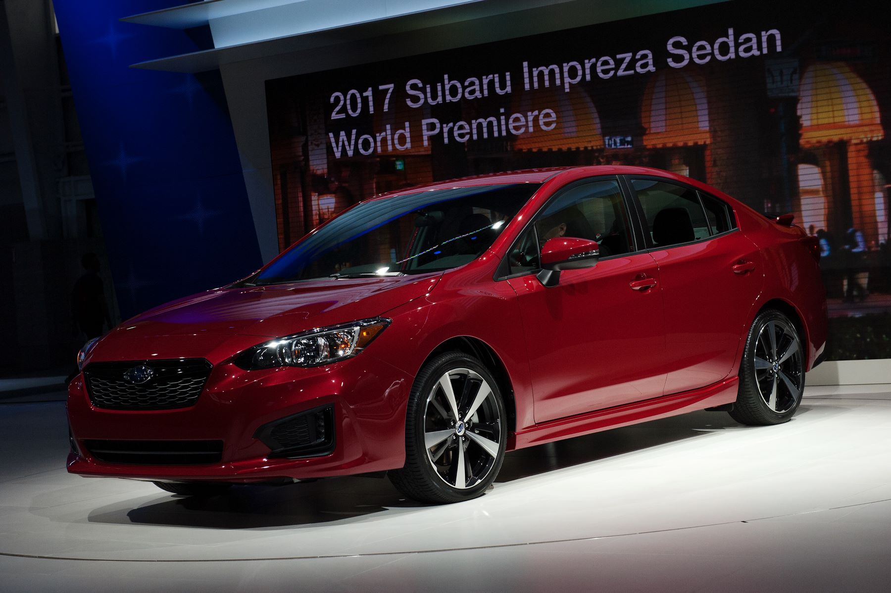 A red 2017 Subaru Impreza sedan introduced at the New York International Auto Show