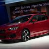 A red 2017 Subaru Impreza sedan introduced at the New York International Auto Show