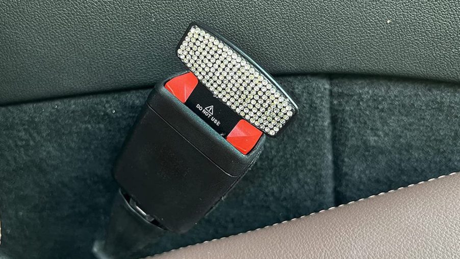 A picture of a seatbelt alarm stopper being used in place of a seatbelt.