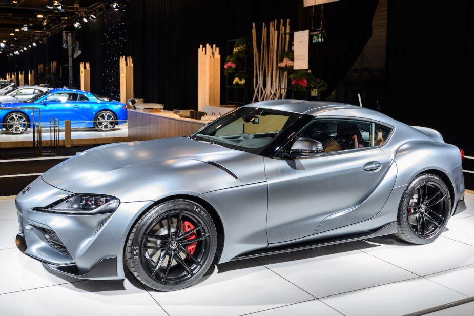 A Toyota Supra with black wheels on display.