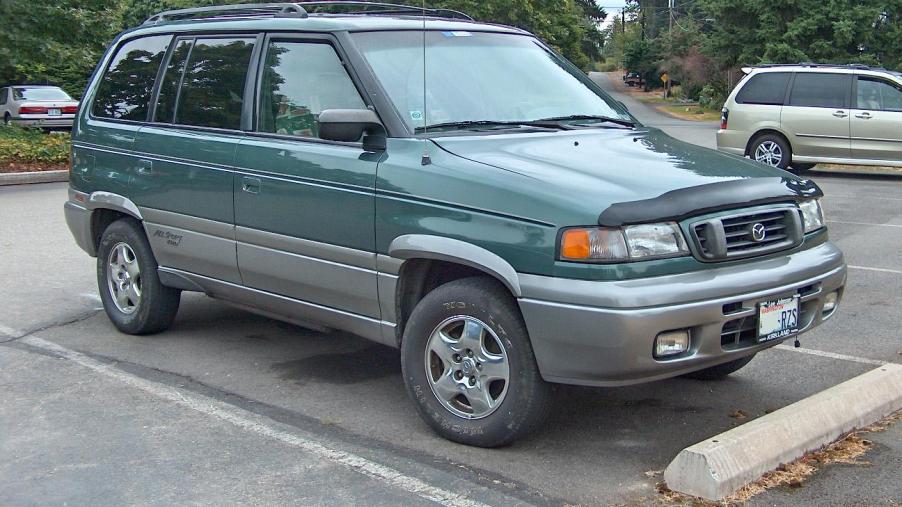 A green 1997 Mazda MPV van sits in a parking lot.