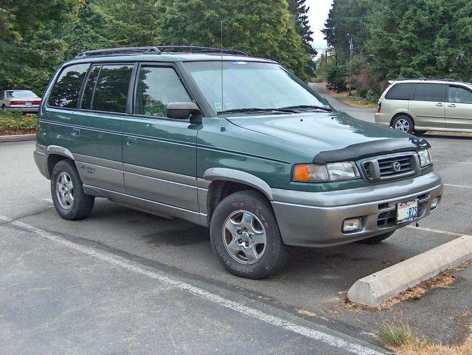 A green 1997 Mazda MPV van sits in a parking lot.