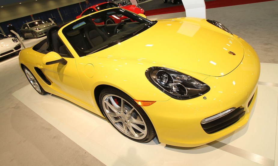 A yellow 2012 Porsche Boxster, which is a used luxury sports cars