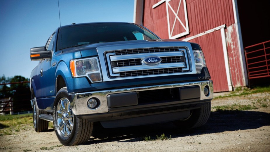 Blue 2014 Ford F-150 sitting next to a barn