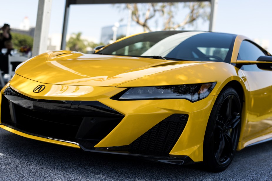 A yellow 2022 Acura NSX parked indoors. 