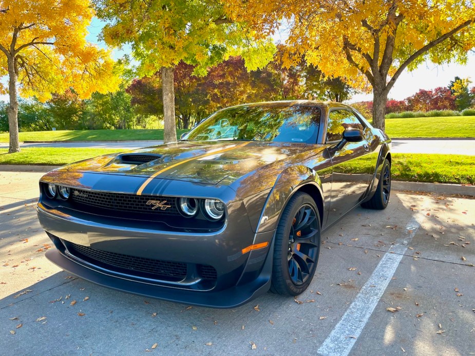 A front corner view of the 2022 Dodge Challenger R/T Scat Pack in front of trees.