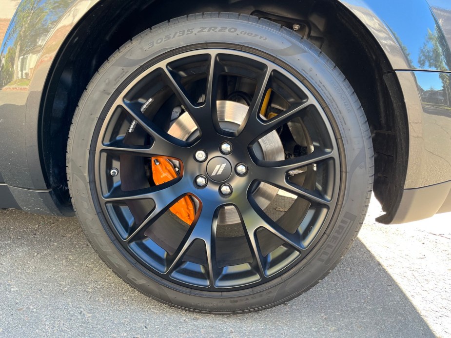 A view of the wheel and orange brake caliper on the 2022 Dodge Challenger R/T Scat Pack