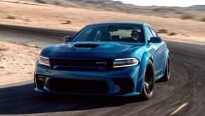 A blue 2022 Dodge Charger SRT Hellcat Redeye muscle car driving on a desert highway