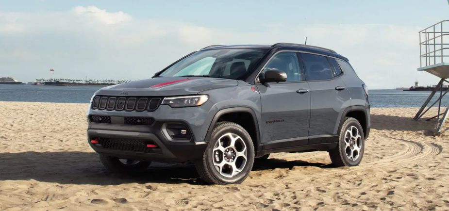 2022 Jeep Compas parked on the beach. It's one of the best SUV deals of October 2022.