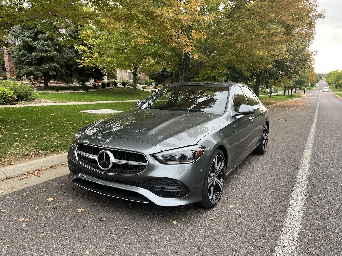 A front view of the 2022 Mercedes-Benz C-Class near a tree